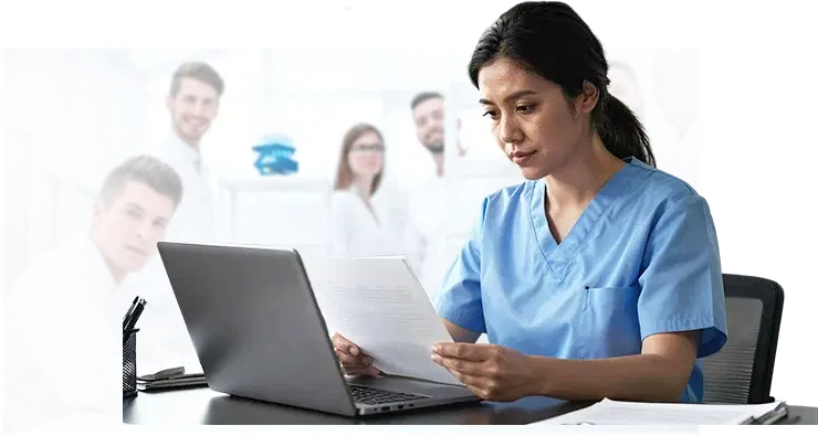Clinical team member reviewing payer contracts at a laptop